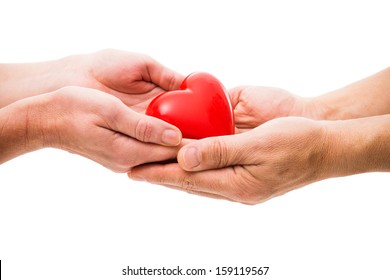 Red heart at the human hands isolated on white - Shutterstock ID 159119567