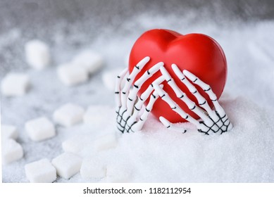 Red Heart Inside The Ghost Hand Bone Rise Up From The White Granulation Sugar And Cube Sugar Background