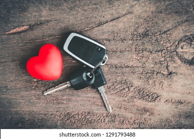 Red Heart And Key Car On Old Wooden Table. Love And Travel Concept. Copy Space.