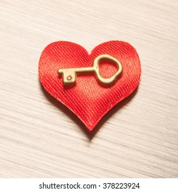 Red heart with the key on a metal surface - Shutterstock ID 378223924