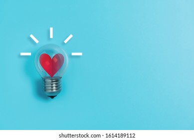 Red Heart In Light Bulb On Blue Background With Copy Space. Valentine's Day, Creative Idea, Inspiration Concept.