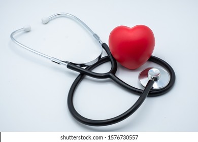 Red Heart And Medical Stethoscope. Close Up. Placed On The Table With Space To Put Text. Heart Health Concept Health Insurance. World Health Day. Human Health That Needs To Be Examined And Treated.