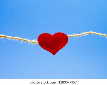 Red heart on light blue background, concept of eternal love