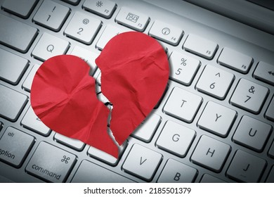 Red heart paper on keyboard computer background. Online internet romance scam or swindler in website application dating concept. Love is bait or victim.