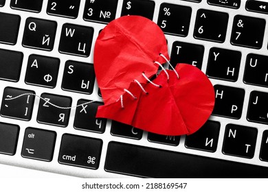 Red Heart Paper On Keyboard Computer Background. Online Internet Romance Scam Or Swindler In Website Application Dating Concept. Love Is Bait Or Victim.