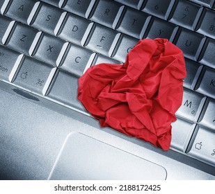 Red Heart Paper On Keyboard Computer Background. Online Internet Romance Scam Or Swindler In Website Application Dating Concept. Love Is Bait Or Victim.