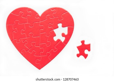 Red Heart Puzzle And Piece Isolated On White