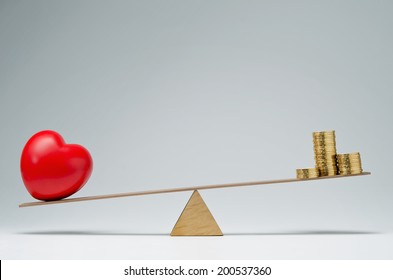 Red Heart Shape And Money Coins Stack Balancing On A Seesaw