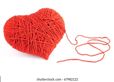 Red heart shape symbol made from wool isolated on white background