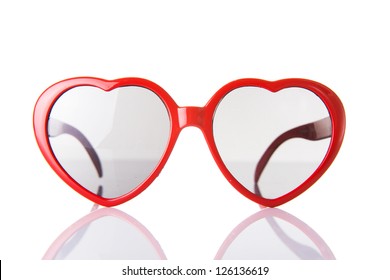 Red Heart Shaped Plastic Glasses On White Background