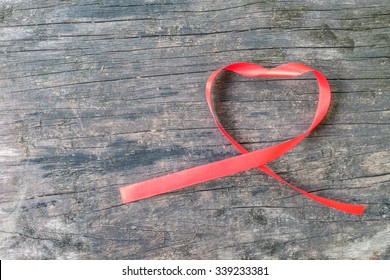 Red Heart Shaped Ribbon Awareness On Old Aged Wood For World Aids Day Campaign 