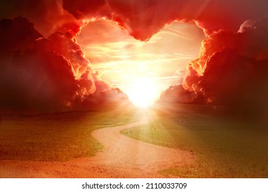  Red heart shaped sky at sunset. Beautiful landscape with road and clouds.Love background with copy space. Road to love 
