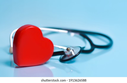 Red Heart And A Stethoscope On Blue Background.Medicine, Healthcare, Science Concept.