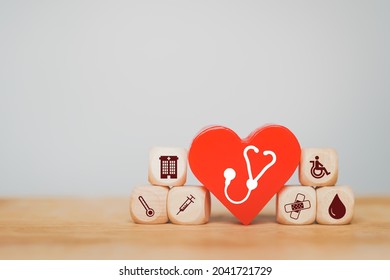 Red Heart With White Stethoscope Sign And Health And Medical Icon On Wood Block For Wellness, Wellbeing, Annual Health Checking And Insurance Concept