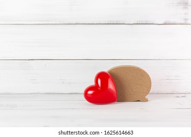 Red Heart with Wooden Blank Speech Bubble on white wood background. Communication of Love concept with Copy Space.