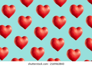 Red hearts, creative pattern against bright blue background. Love and passion inspired. 