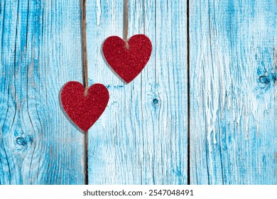 Red hearts on a blue wooden background. Rustic style. Valentine's Day - Powered by Shutterstock