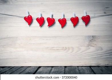 Red hearts on gray wooden background - Shutterstock ID 372000040