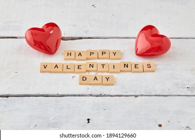 Red hearts with Valentine's day text on wood white background - Shutterstock ID 1894129660