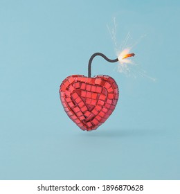 Red Heart-shaped Fuse Bomb Against Pastel Blue Background. Valentines Day Party Concept. Minimal Style.