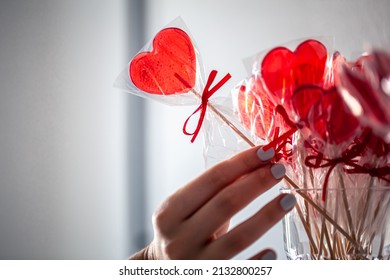 Red Heart-shaped Lollipops On The Counter Of A Candy Store.