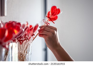 Red Heart-shaped Lollipops On The Counter Of A Candy Store.