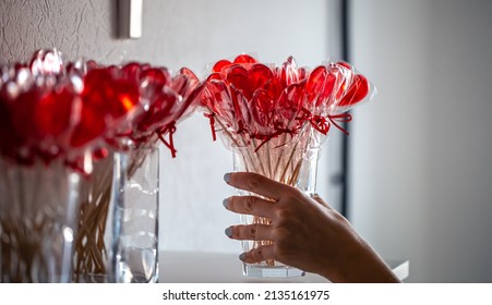 Red Heart-shaped Lollipops On The Counter Of A Candy Store.