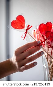 Red Heart-shaped Lollipops On The Counter Of A Candy Store.