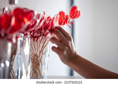 Red Heart-shaped Lollipops On The Counter Of A Candy Store.