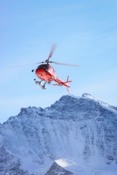 Red Helicopter At Swiss Alpine Mountains In Winter, Gsteigwiler, Switzerland