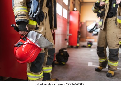 Red helmet in fireman's hand