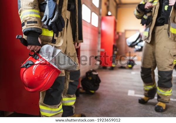Red helmet in fireman\'s\
hand