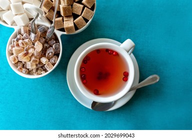 Red herbal tea with cranberries in ceramic white cup with white and cane sugar on blue tablecloth. Food background with copy space. Flat lay style. Food and drink concept. - Powered by Shutterstock