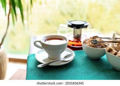 Red herbal tea with cranberries in ceramic white cup with white and cane sugar on blue tablecloth. Food background with copy space. Food and drink concept. - Powered by Shutterstock