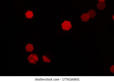 Red hexagonal bokeh lights with fabric shadows on dark background from unfocused macro, created with red fairy lights and a vintage lens.  - Powered by Shutterstock - Get 15% off with code: PIKWIZARD15