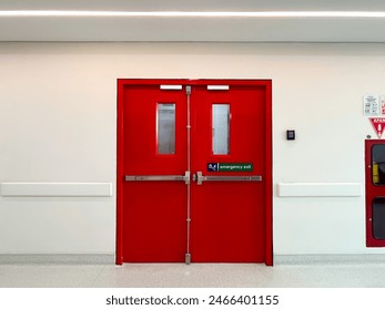 The red hospital emergency door is equipped with emergency exit signs and emergency stairs - Powered by Shutterstock