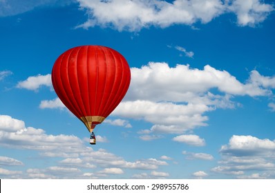 Red Hot Air Balloon In Blue Cloudy Sky