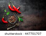 red hot chili pepper corns and pods on dark vintage metal culinary background, top view