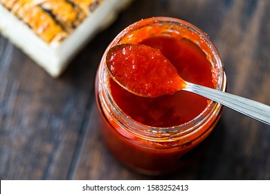 Red Hot Chili Pepper Sauce for Artisan Cheese made with Vinegar and Sugar in Glass Bowl with Spoon. - Powered by Shutterstock