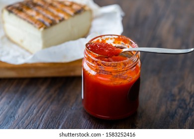 Red Hot Chili Pepper Sauce for Artisan Cheese made with Vinegar and Sugar in Glass Bowl with Spoon. - Powered by Shutterstock