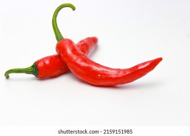 Red Hot Chili Peppers. Pile of fresh red bird's eye chili peppers isolated on white background - Shutterstock ID 2159151985