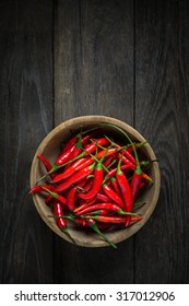 Red Hot Chili Peppers In Wooden Bowl On Old Wooden Background, Overhead View Of Chili Pepper On Wood Background