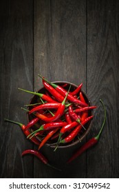 Red Hot Chili Peppers In Wooden Bowl On Old Wooden Background, Overhead View Of Chili Pepper On Wood Background