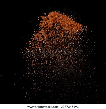 Red Hot Chilli flying explosion, red grain chilli explode abstract cloud fly. Beautiful complete seed chilly splash in air, food object design. Selective focus freeze shot black background isolated