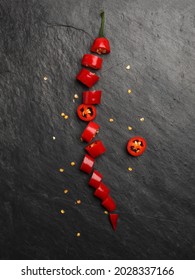 Red Hot Chilli Pepper On Dark Black Rough Slate Stone Surface Background