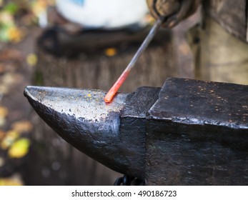 Red Hot Iron Rod On Anvil In Outdoor Rural Smithy