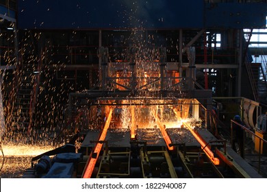 Red hot steel metal billets after molten steel casting.  Continuous casting machine. Background of the blacksmith and metallurgical industry. - Shutterstock ID 1822940087