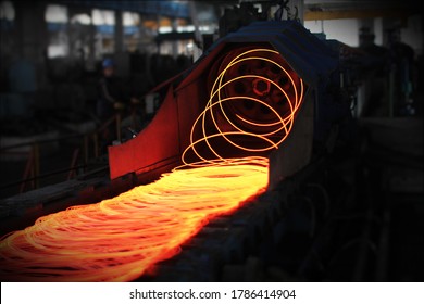 Red hot steel metal wire rods or coils after molten steel casting.  Continuous casting machine. Background of the blacksmith and metallurgical industry. - Powered by Shutterstock