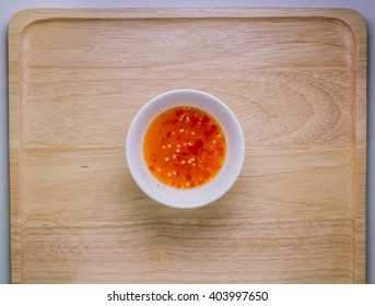 Red Hot Sweet Chilli Sauce Over Old Wooden Background
