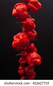 Red hot Trinidad moruga scorpion peppers black background